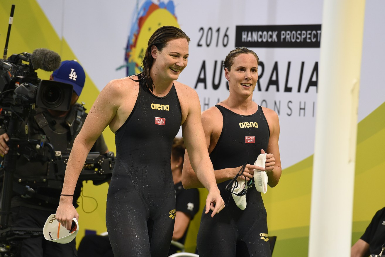 Cate Campbell (left) smiles with sister Bronte Campbell after swimming in the Women's 100m Freestyle Semi-Final. Photo: Dave Hunt, AAP.