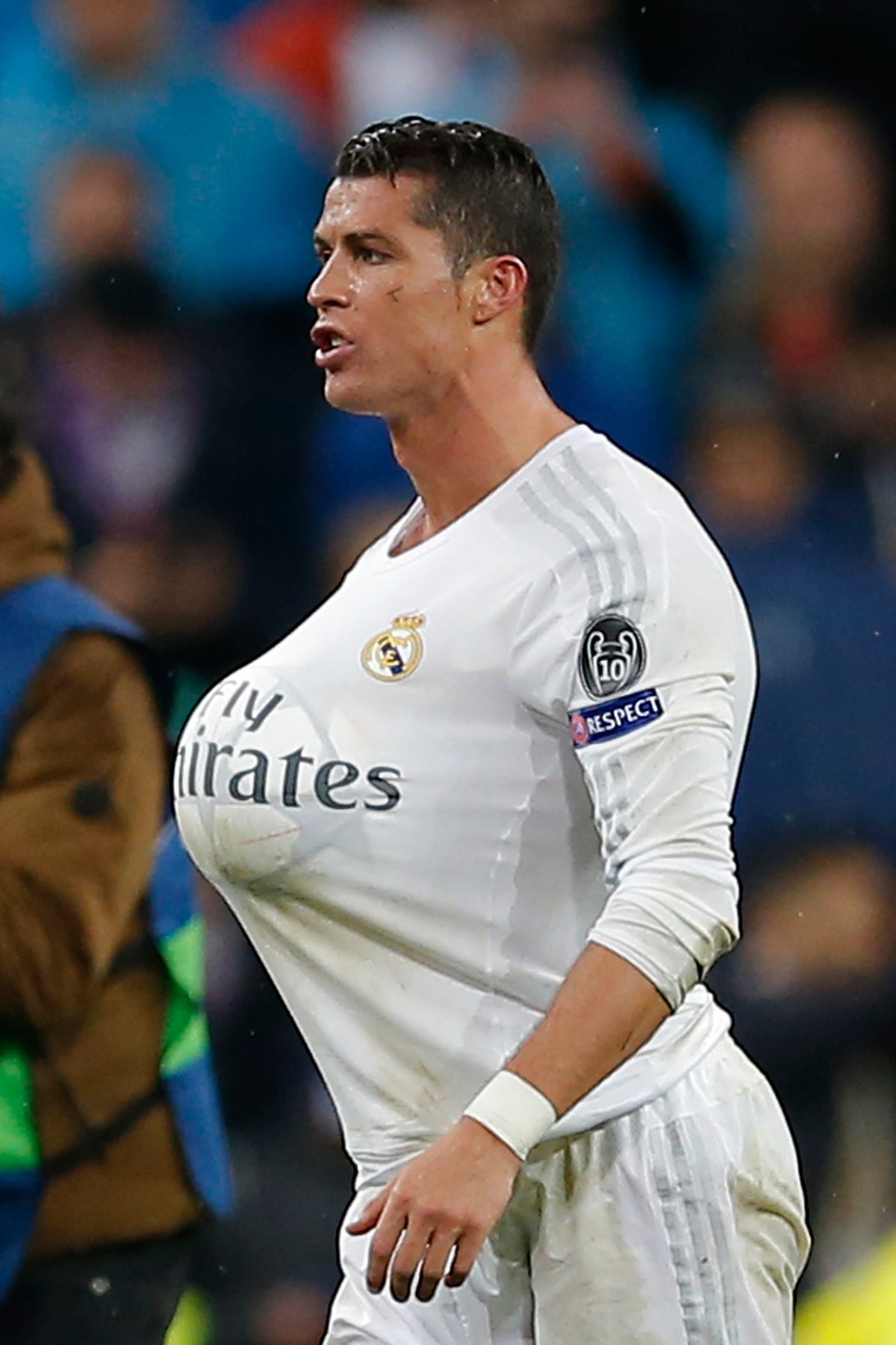 Real Madrid's Cristiano Ronaldo who scored three times walks on the pitch with the ball under his shirt after the Champions League 2nd leg quarterfinal soccer match between Real Madrid and VfL Wolfsburg at the Santiago Bernabeu stadium in Madrid, Spain, Tuesday April 12, 2016. (AP Photo/Paul White)