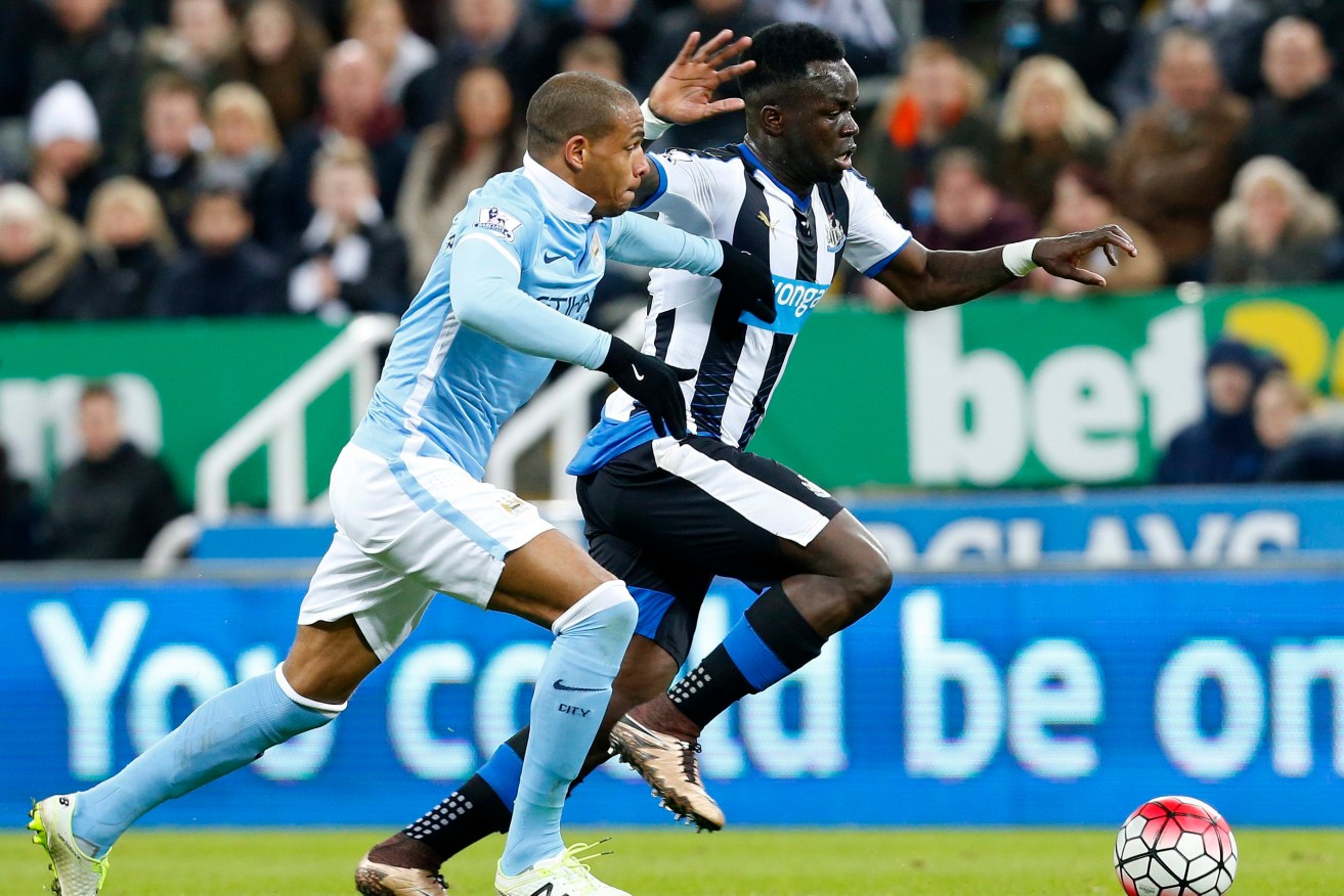 Manchester City's Fernando vies with Newcastle United's Cheick Tiote. Photo: LINDSEY PARNABY, EPA. 
