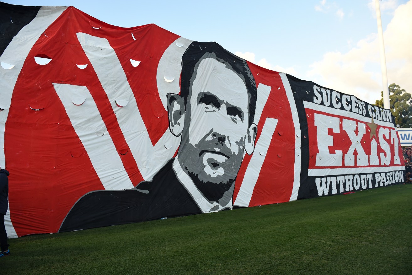 Wanderers supporters erect a banner with an image of coach Tony Popovic during last week's semi-final against Brisbane Roar. Photo: Dan Himbrechts, AAP.