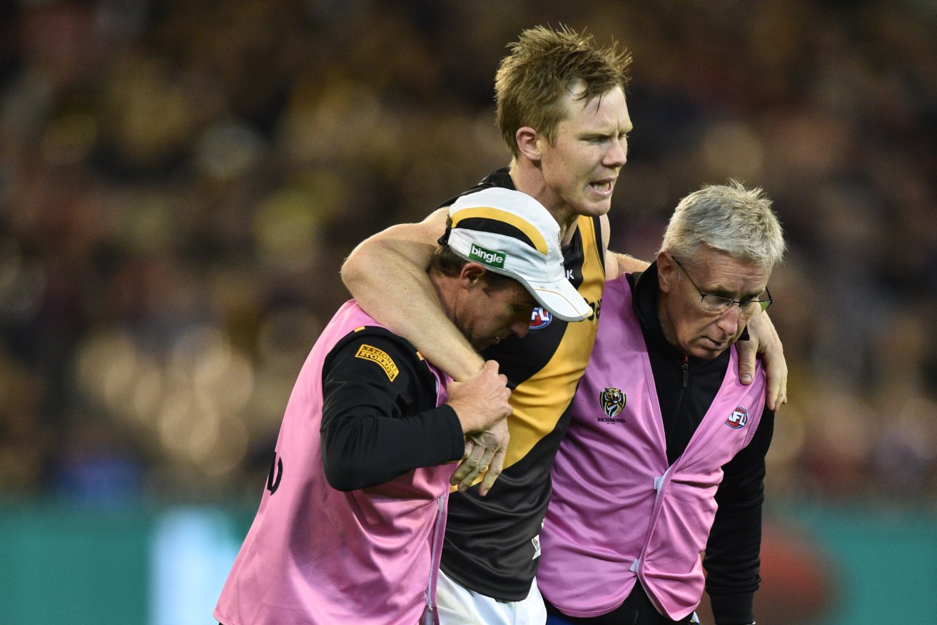 Jack Riewoldt is carried from the ground during Richmond's loss to the Demons. Photo: Julian Smith, AAP.