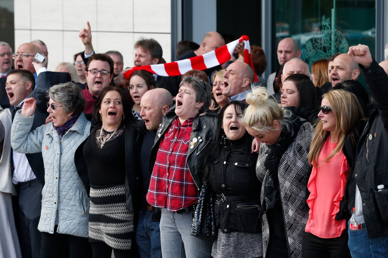 Relatives of those who died in the Hillsborough disaster sing 'You'll Never Walk Alone' outside  outside the Hillsborough Inquest in Warrington. Photo: Joe Giddens, PA/AP.