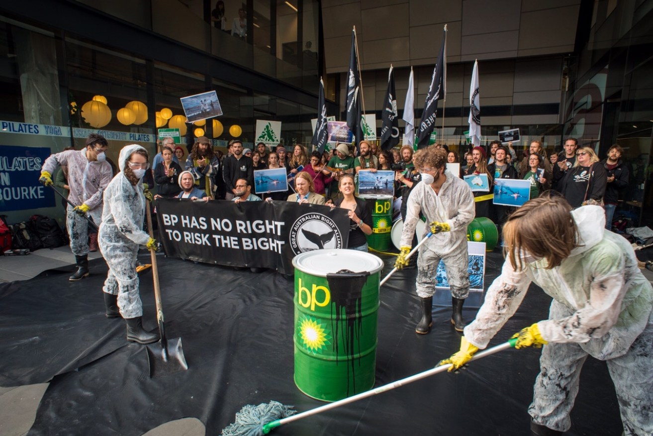 Protestors outside BP's Melbourne offices today clean up a fake oil spill. Supplied image