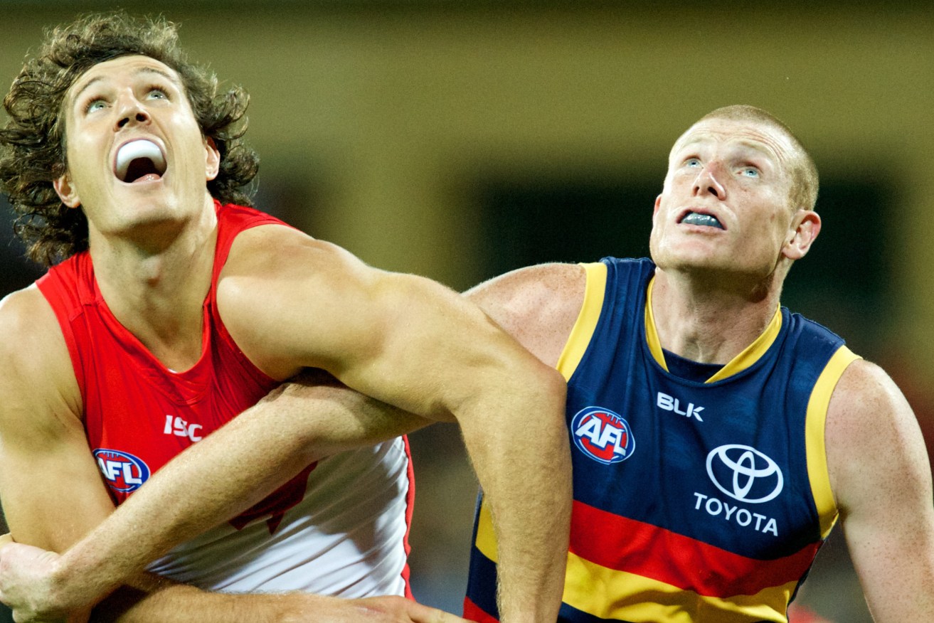 Kurt Tippett and Sam Jacobs wrestle in the ruck contest. Photo: Michael Errey, InDaily.