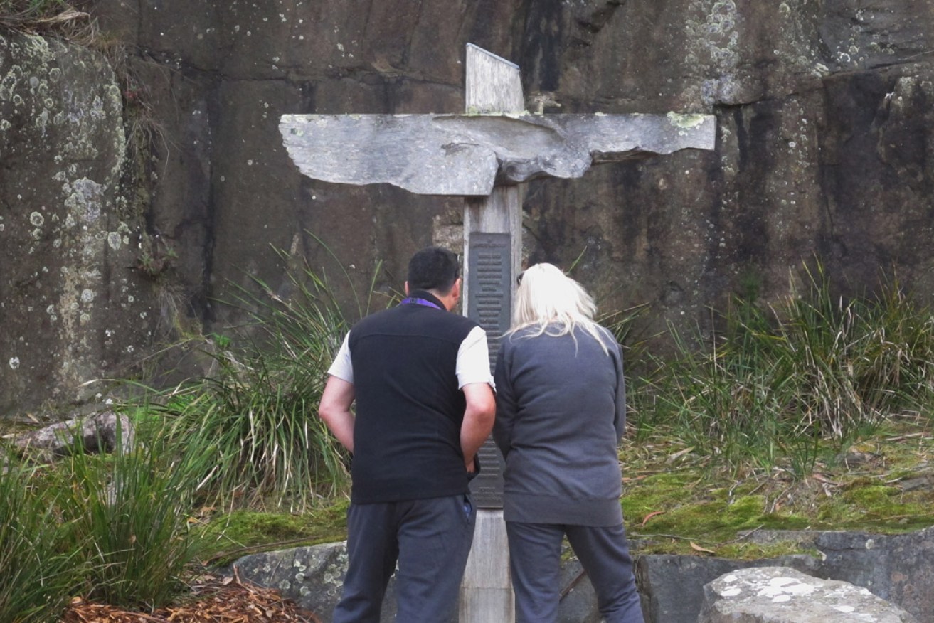 Tourists read names on a memorial at the site of the Port Arthur massacre. Photo: AP