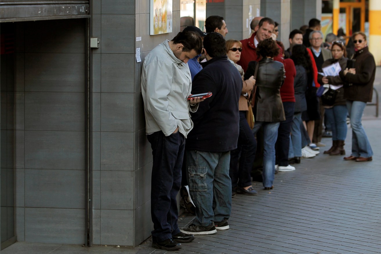 People queue to register for job placement in Madrid. Spain was hit hard by the Global Financial Crisis. Photo: AP/Andres Kudacki