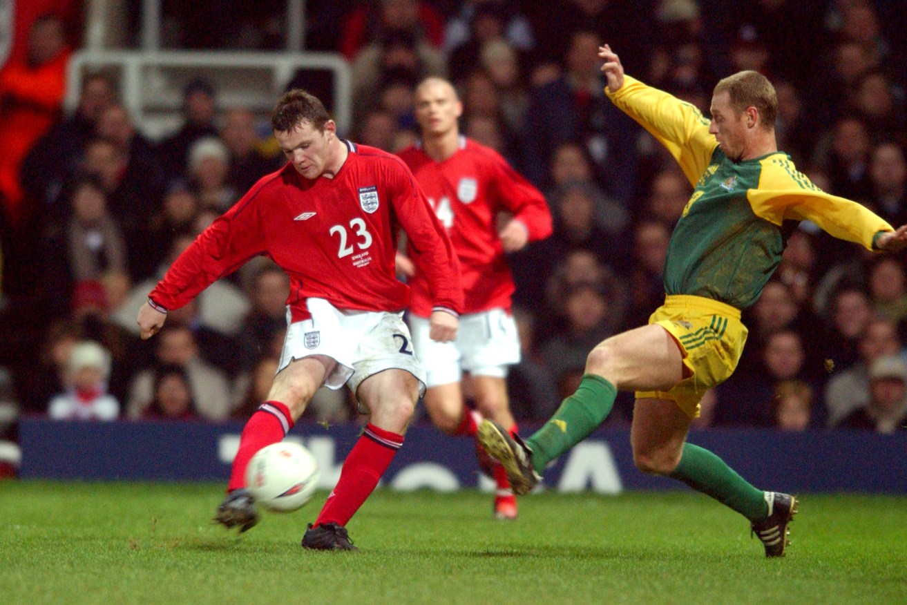 A young Wayne Rooney gets a shot away in his debut against Australia, back in 2003. Photo: AAP.