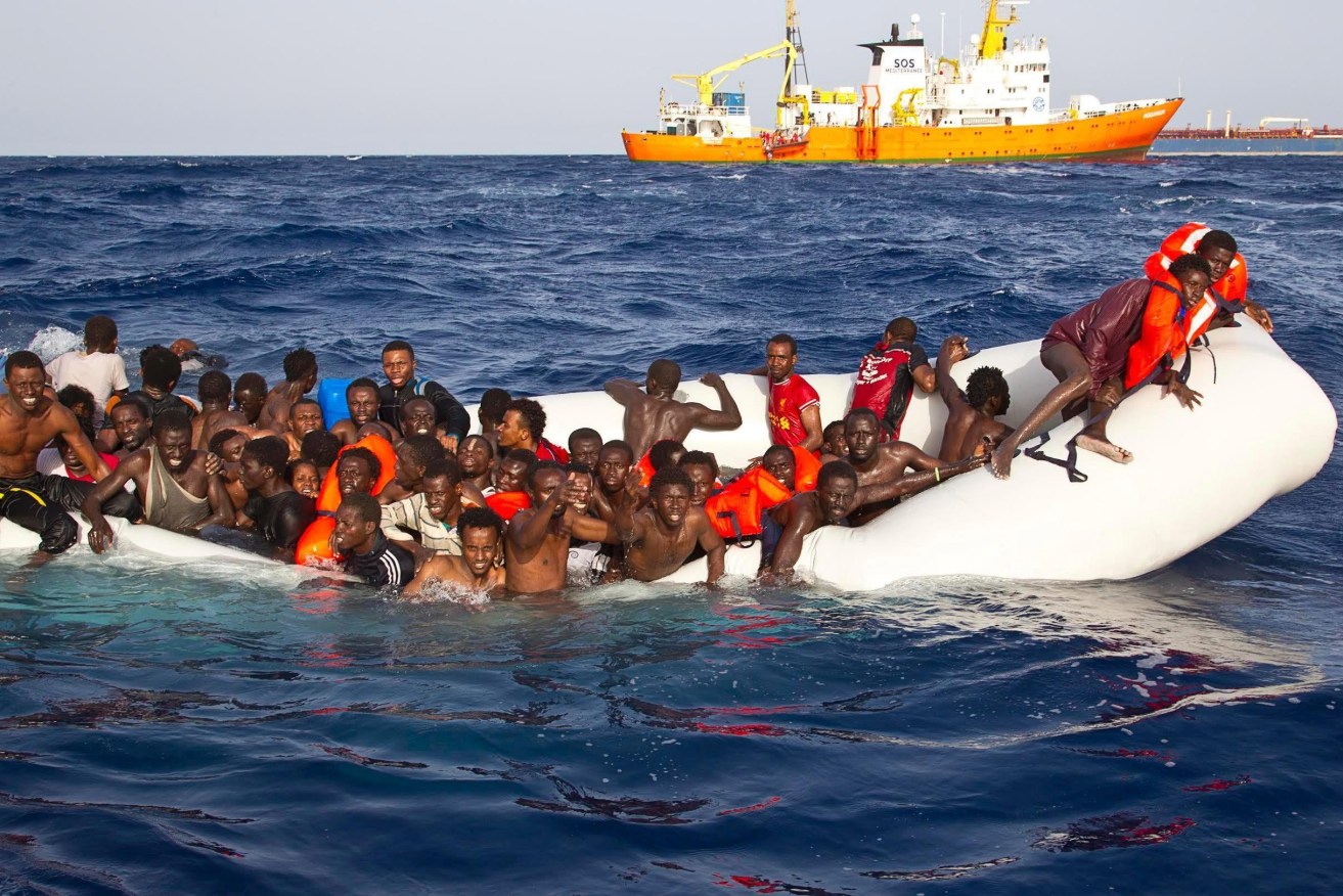 Migrants on a sinking inflatable boat before being rescued and taken to  Lampesusa, Italy, last month. Photo: EPA/ONG SOS MEDITERRANEE