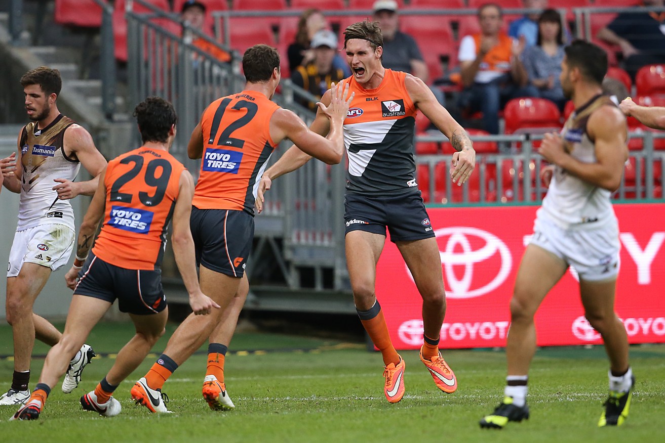 Giant Rory Lobb celebrates a goal as his team hammers the reigning premeirs. Photo: David Moir, AAP.