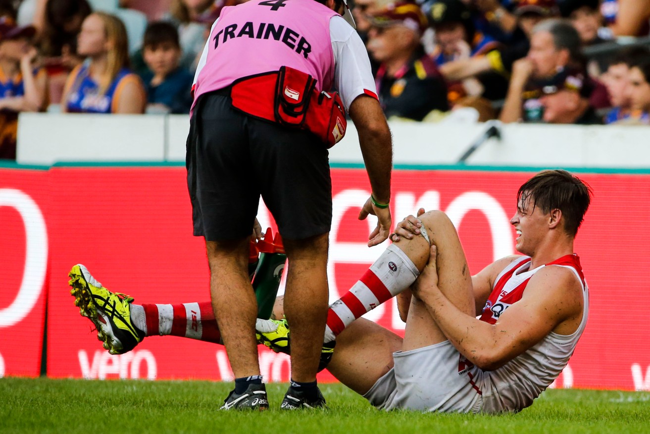 Callum Sinclair on the ground in the incident which prompted the umpires to stop play, Photo: Glenn Hunt, AAP.