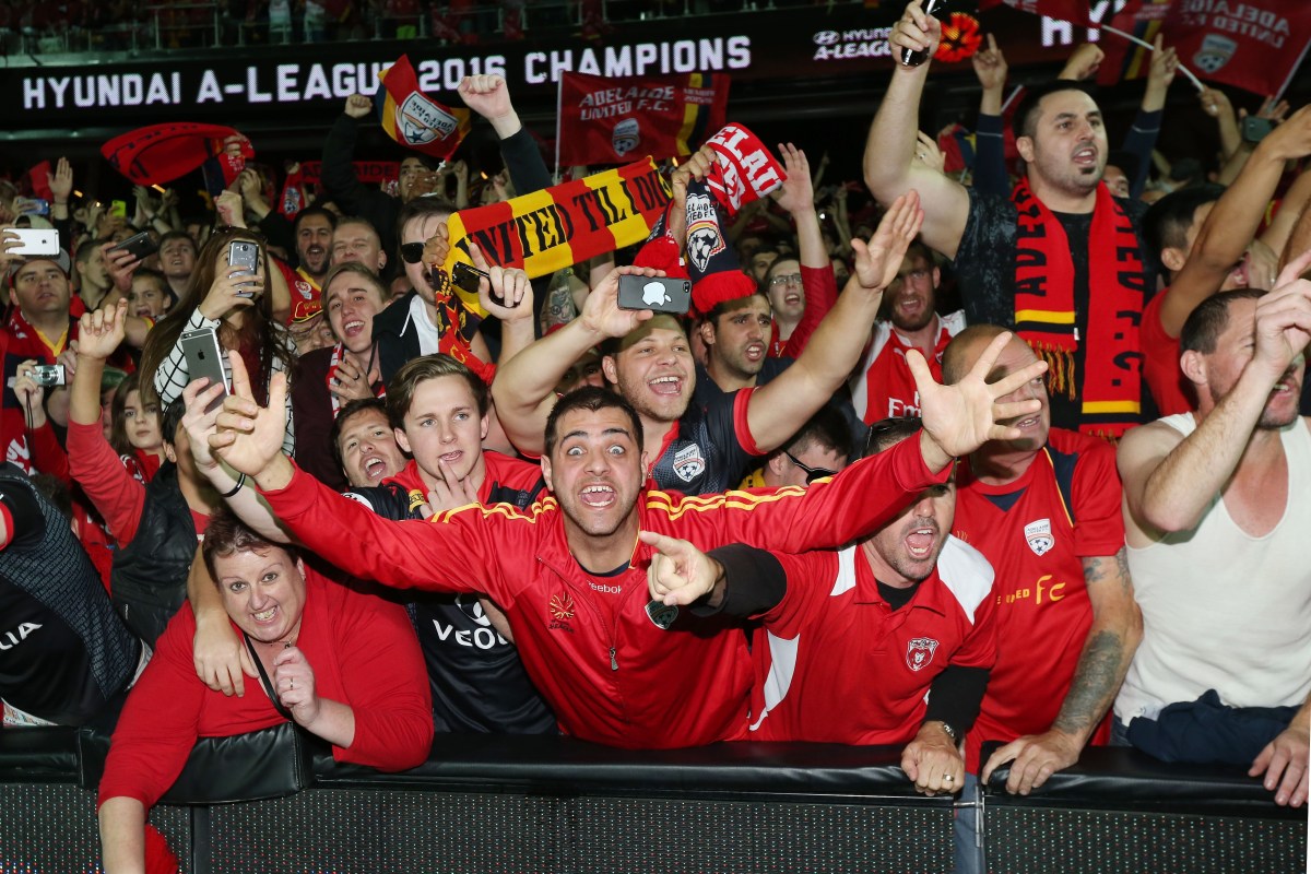 Fans celebrate United's win during the A-League Grand Final between Adelaide United and the Western Sydney Wanderers at Adelaide Oval in Adelaide, Sunday, May 1, 2016. (AAP Image/James Elsby) NO ARCHIVING, EDITORIAL USE ONLY