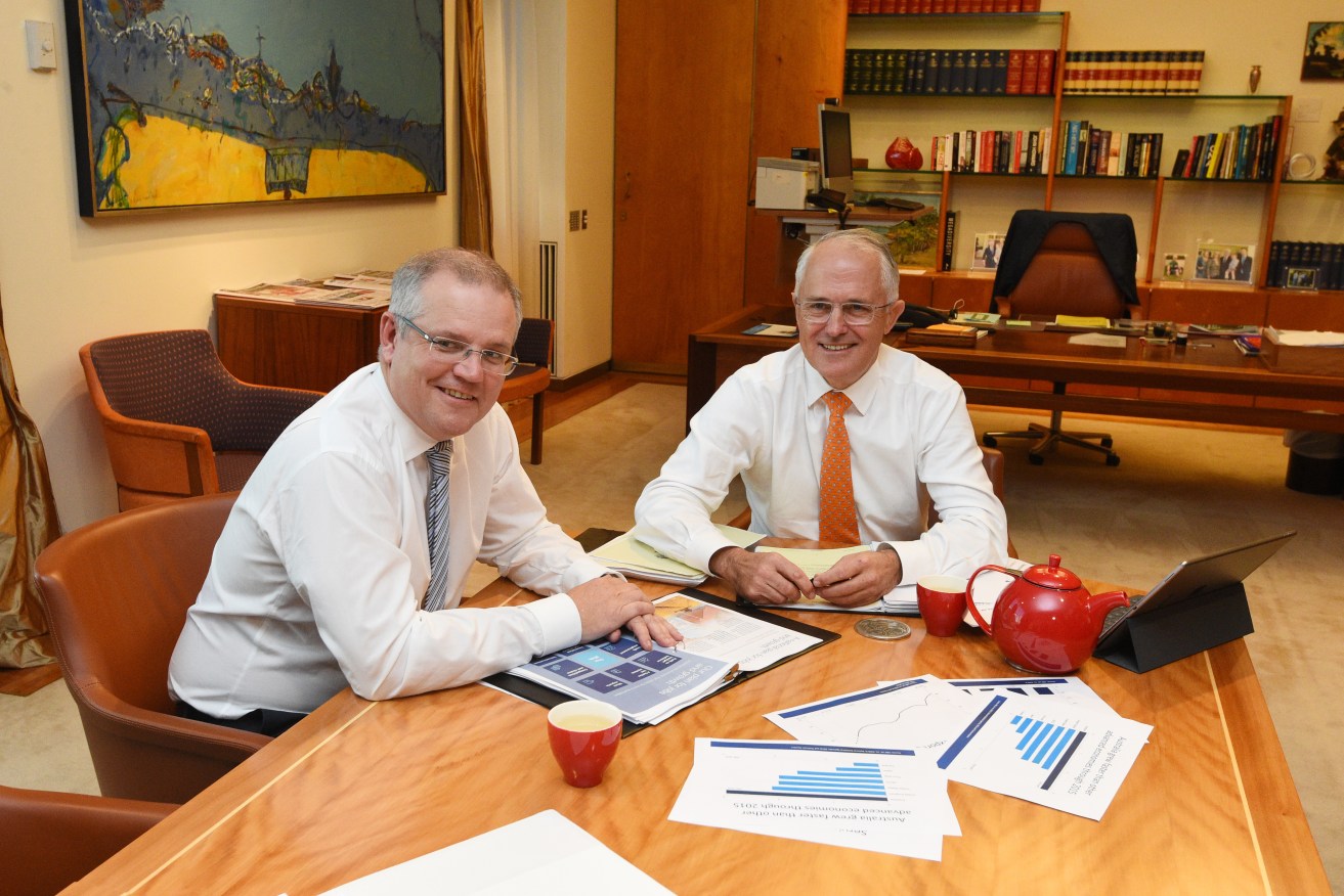 Treasurer Scott Morrison (left) and Prime Minister Malcolm Turnbull looking at the Budget papers in Canberra yesterday. Photo: AAP/Mick Tsikas