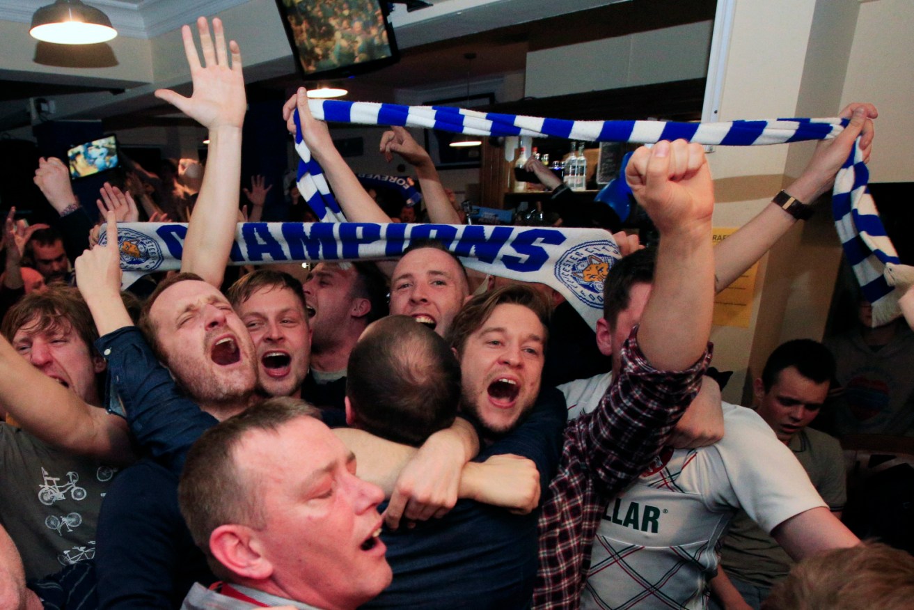Leicester City fans celebrate in the Market Tavern in Leicester after seeing their side crowned Barclays Premier League champions following Tottenham Hotspur's 2-2 draw against Chelsea. Photo: Jonathan Brady, PA Wire.