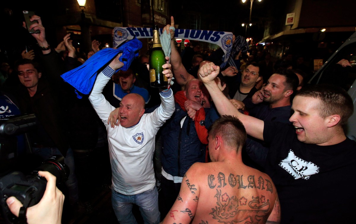 Leicester City fans celebrate in the streets of Leicester after seeing their side crowned English Premier League soccer champions following Tottenham Hotspur's 2-2 draw against Chelsea. The match resulted in Leicester City winning the Premier League, Monday May 2, 2016. (Jonathan Brady/PA via AP) UNITED KINGDOM OUT NO SALES NO ARCHIVE