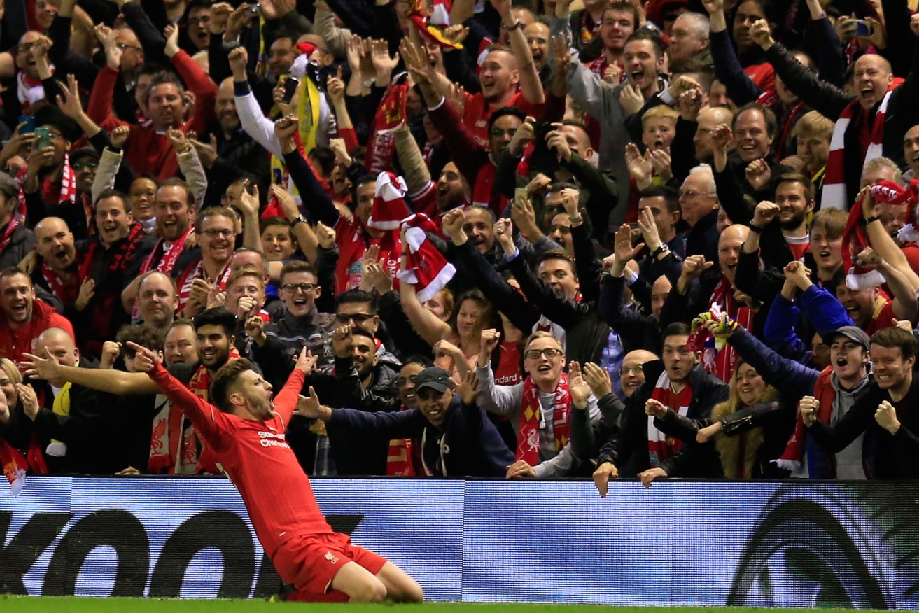 Liverpool's Adam Lallana celebrates after scoring his sides third goal during the Europa League semifinal's second leg. Photo: Jon Super, AP.