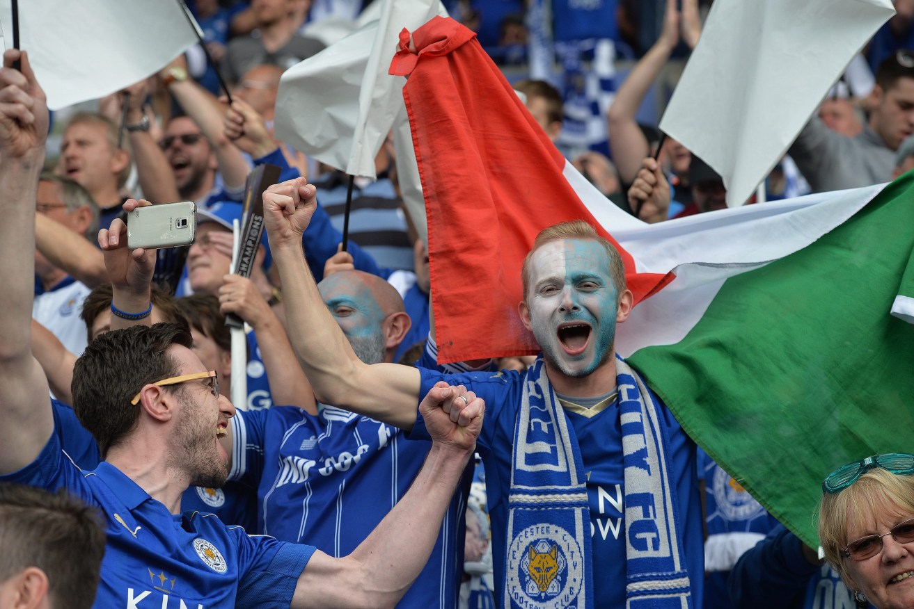 Leicester fans get into the spirit of celebration. Photo: PETER POWELL, EPA. 
