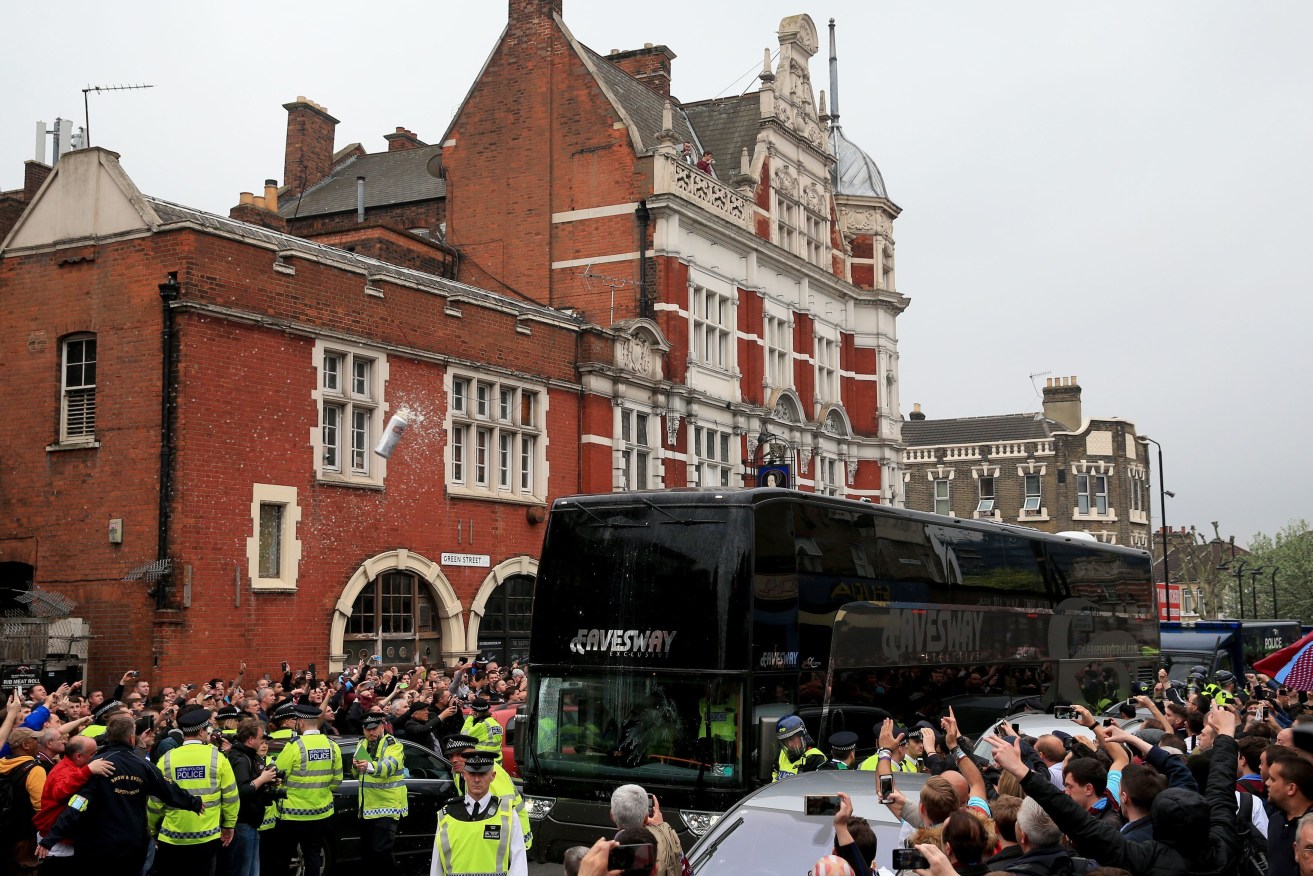 The Manchester United team coach is pelted with beer cans before the farewell match at Upton Park. Photo: Nick Potts, PA Wire.