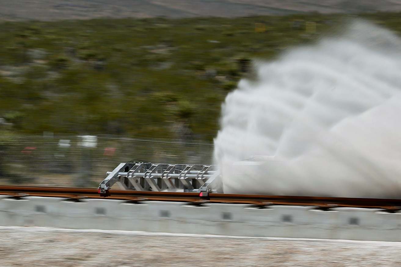 A sled speeds down a track during a test of a Hyperloop One propulsion system. Photo: AP/John Locher
