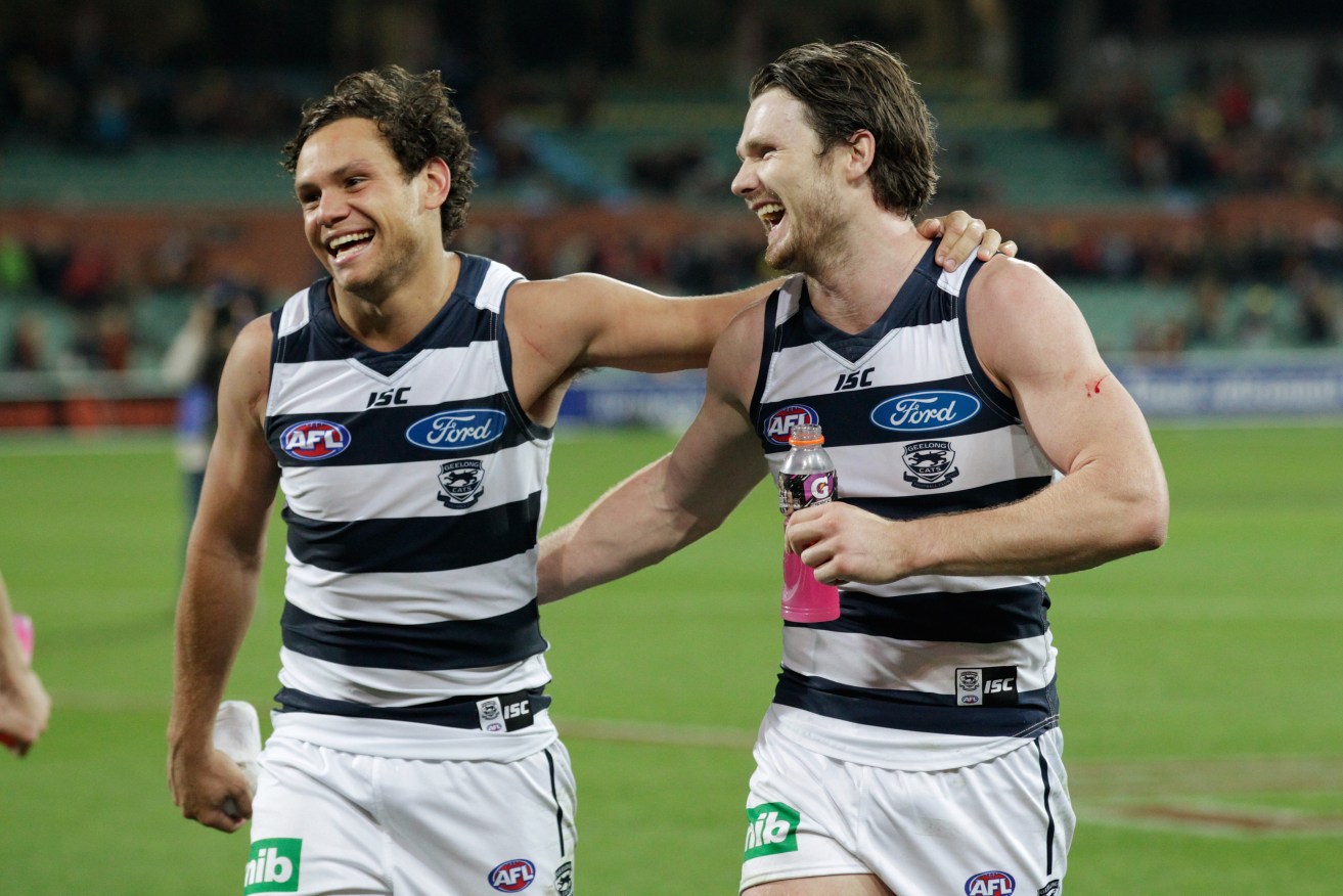 Does he ever stop smiling? Patrick Dangerfield and Steven Motlop share a laugh at the Crows' expense. Photo: Ben Macmahon, AAP.