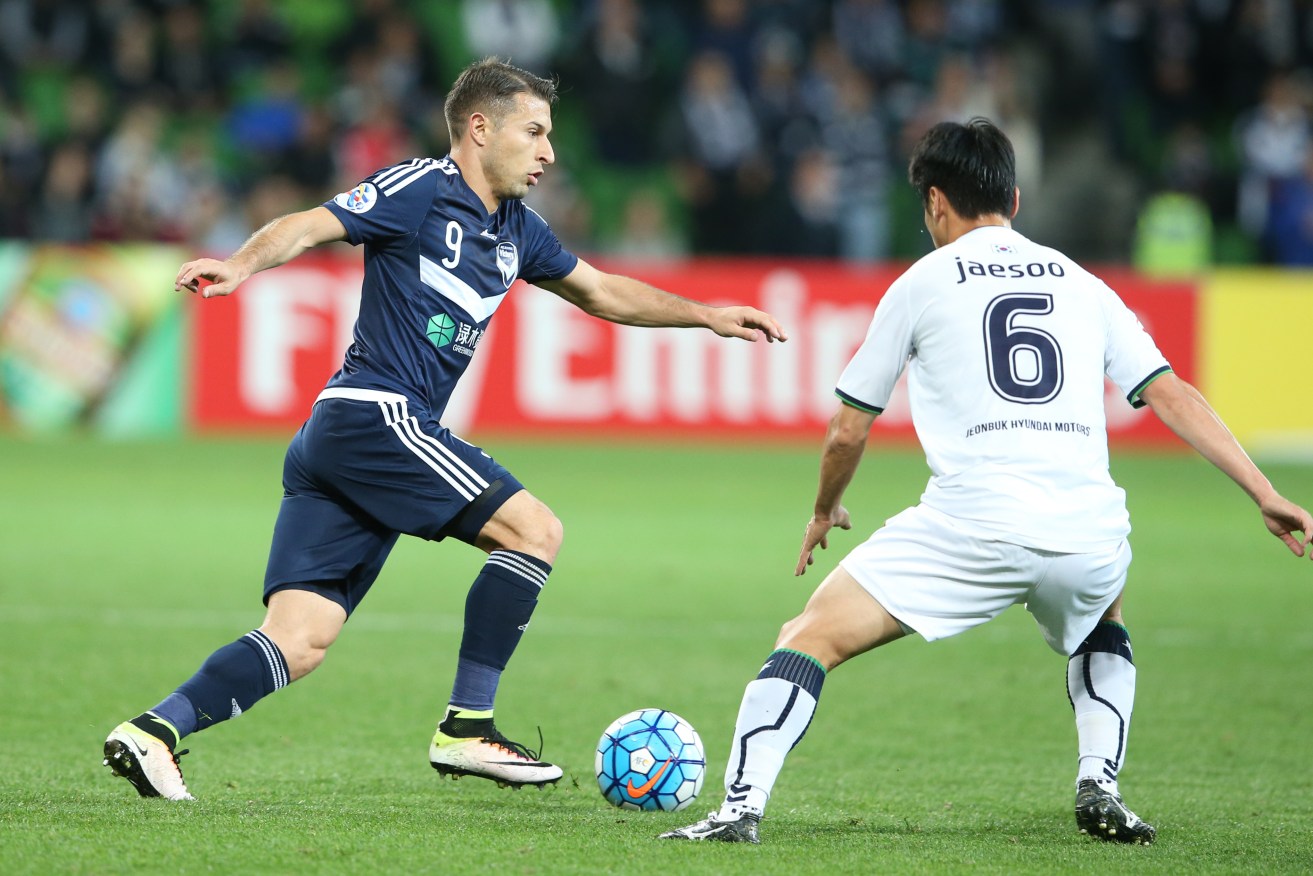 Kosta Barbarouses in action for Victory against Choi Jaesoo for Jeonbuk. Photo: David Crosling, AAP.