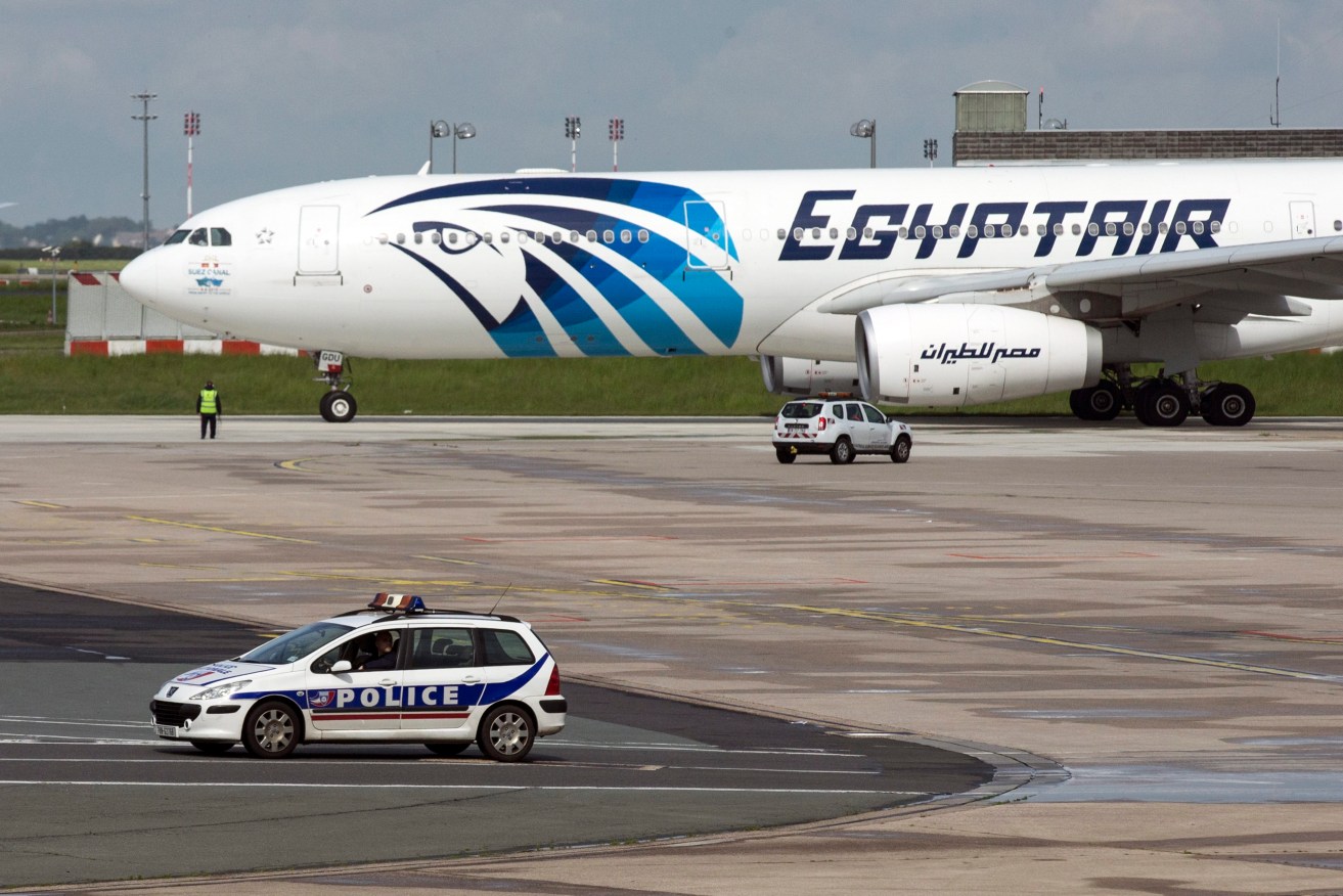 A French police car passes by an EgyptAir plane taking off from the Charles de Gaule airport near Paris. Photo: EPA/ETIENNE LAURENT