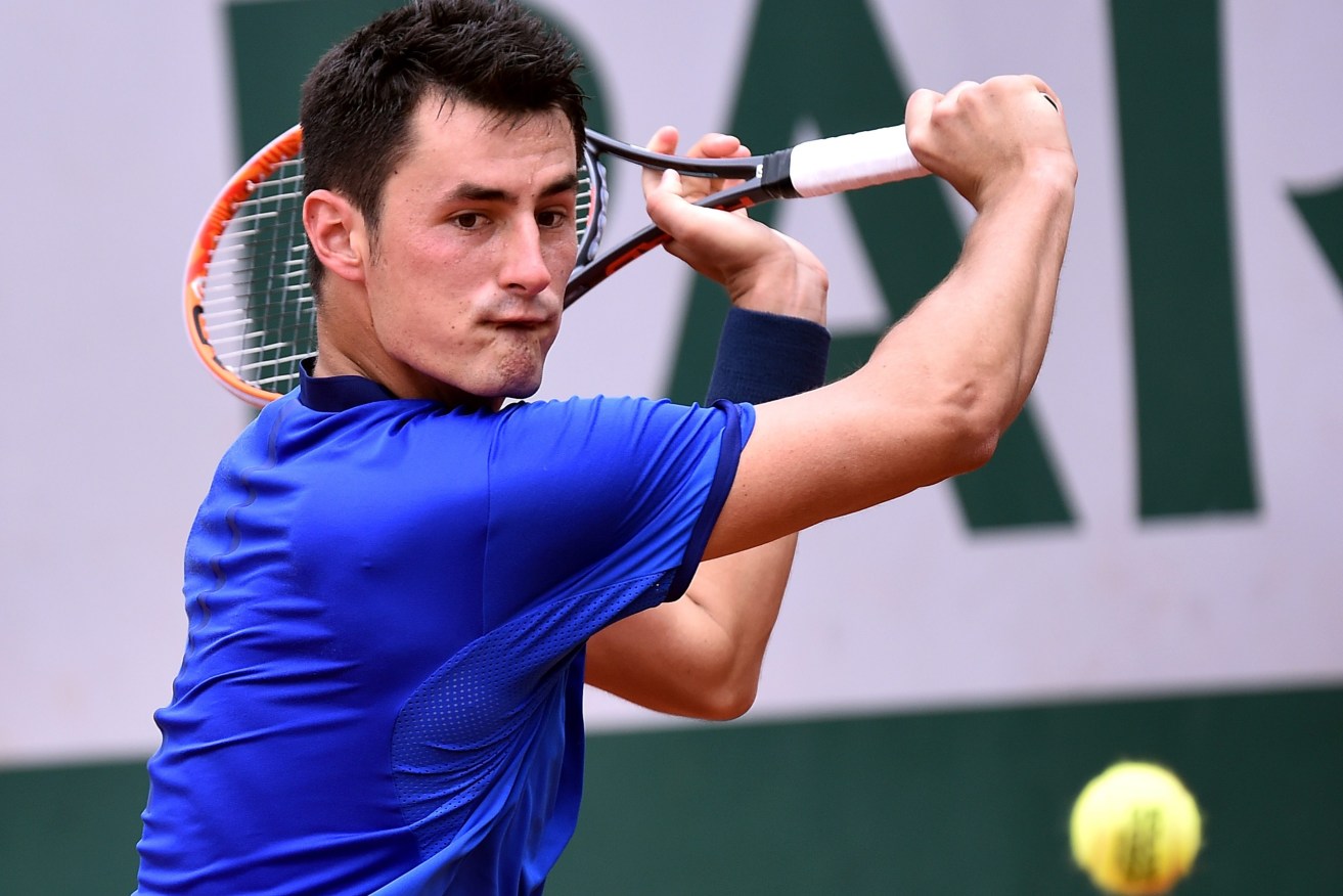 Bernard Tomic in action against Brian Baker of the USA during their first round match at the French Open. Photo: Christophe Petit Tesson, EPA.