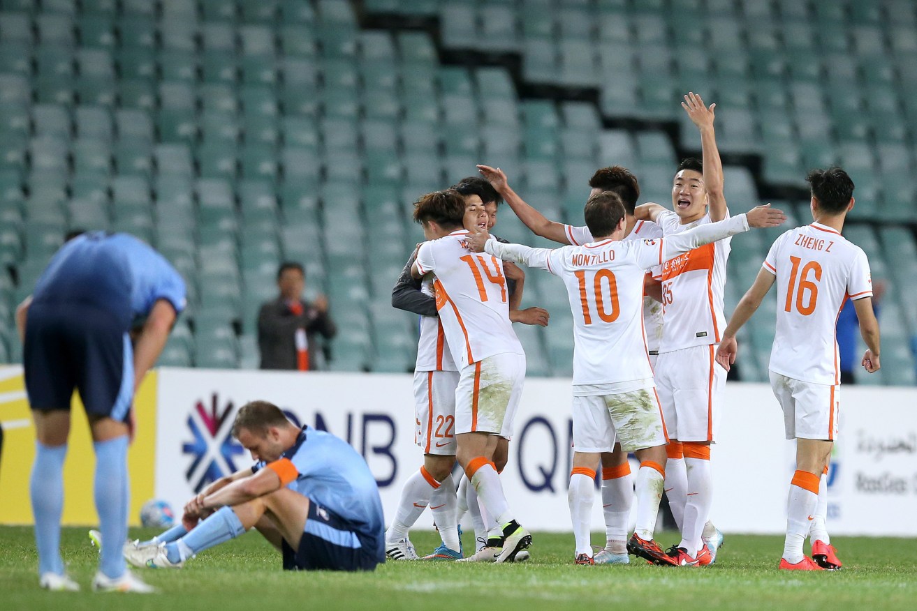 Shandong Luneng FC celebrate their 2-all draw with Sydney FC. Photo: Rick Rycroft, AP.