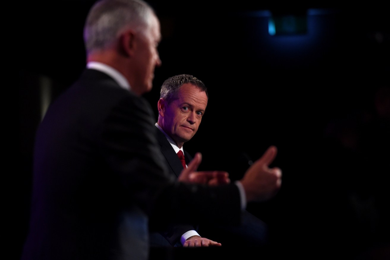 Opposition Leader Bill Shorten listens to Prime Minister Malcolm Turnbull (left) at the leaders' debate at the National Press Club on Sunday night. Photo: AAP/Tracey Nearmy