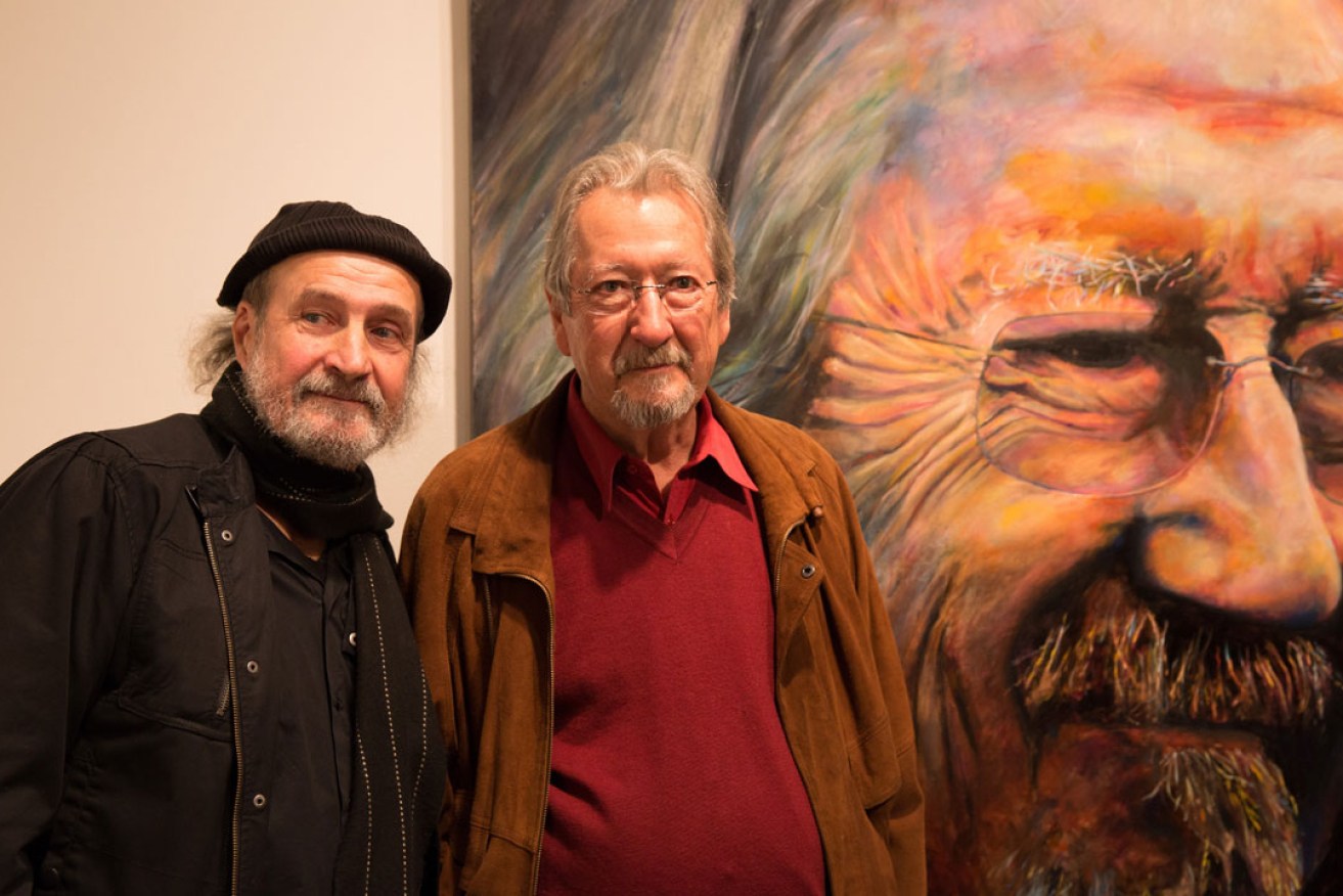 Artist Bruno Jean Grasswill and actor Michael Caton next to Grasswill's 2015 Archibald People's Choice award-winning portrait. Photo: AAP