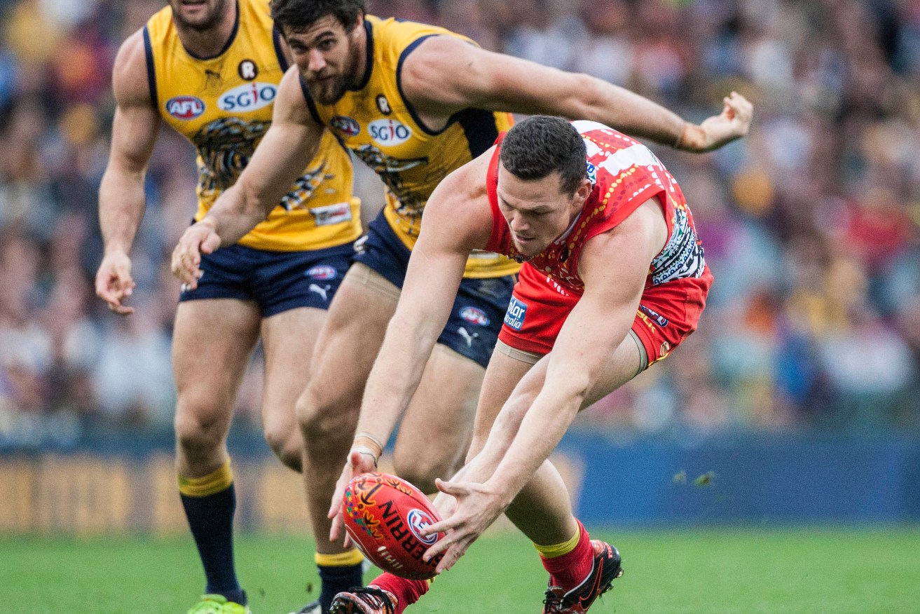 Steven May chases the ball, with Eagle Josh Kennedy in hot pursuit. Photo: Tony McDonough, AAP.