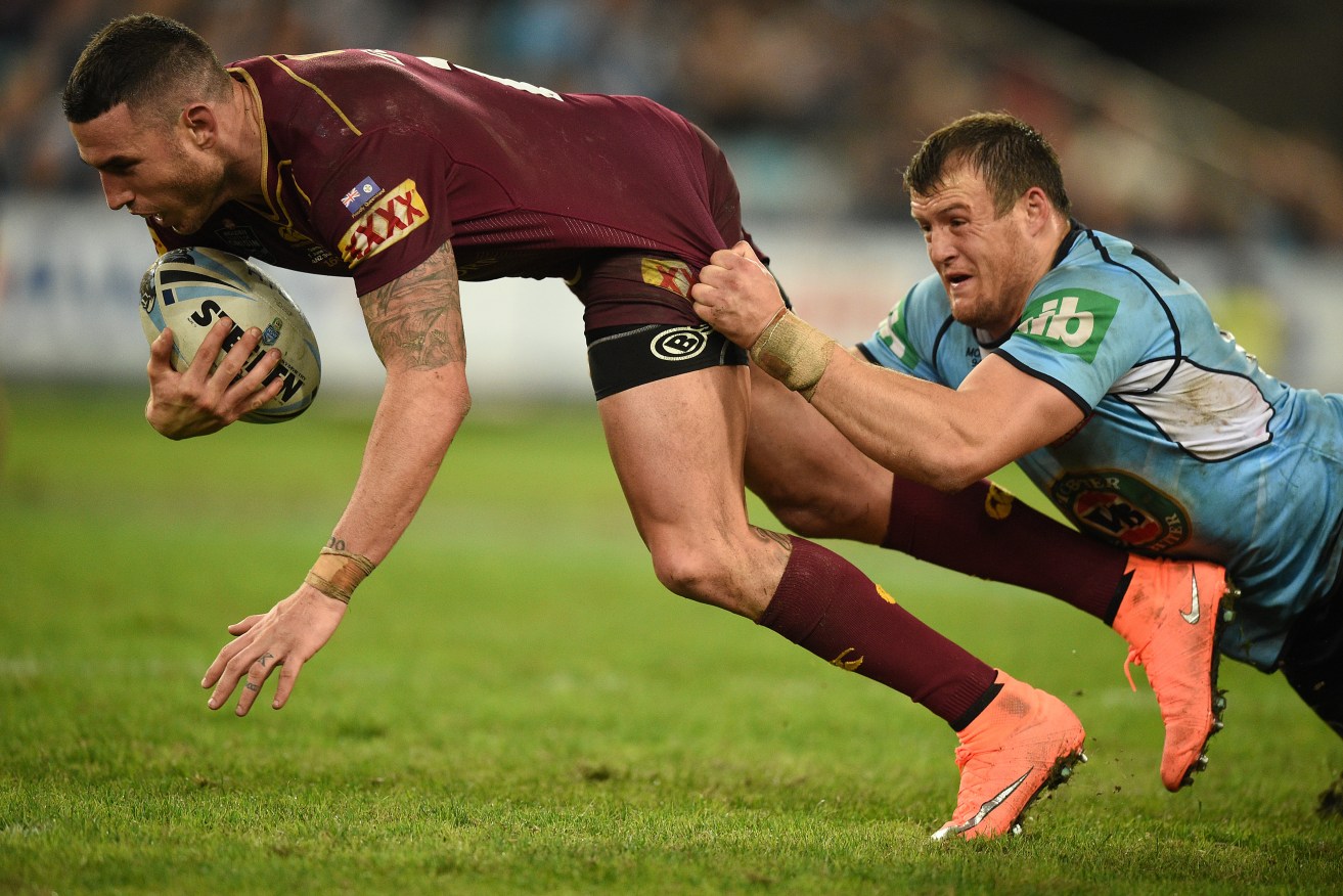 Darius Boyd of the Maroons is tackled by Josh Morris of the Blues during State of Origin Game I. Photo: Dan Himbrechts, AAP.