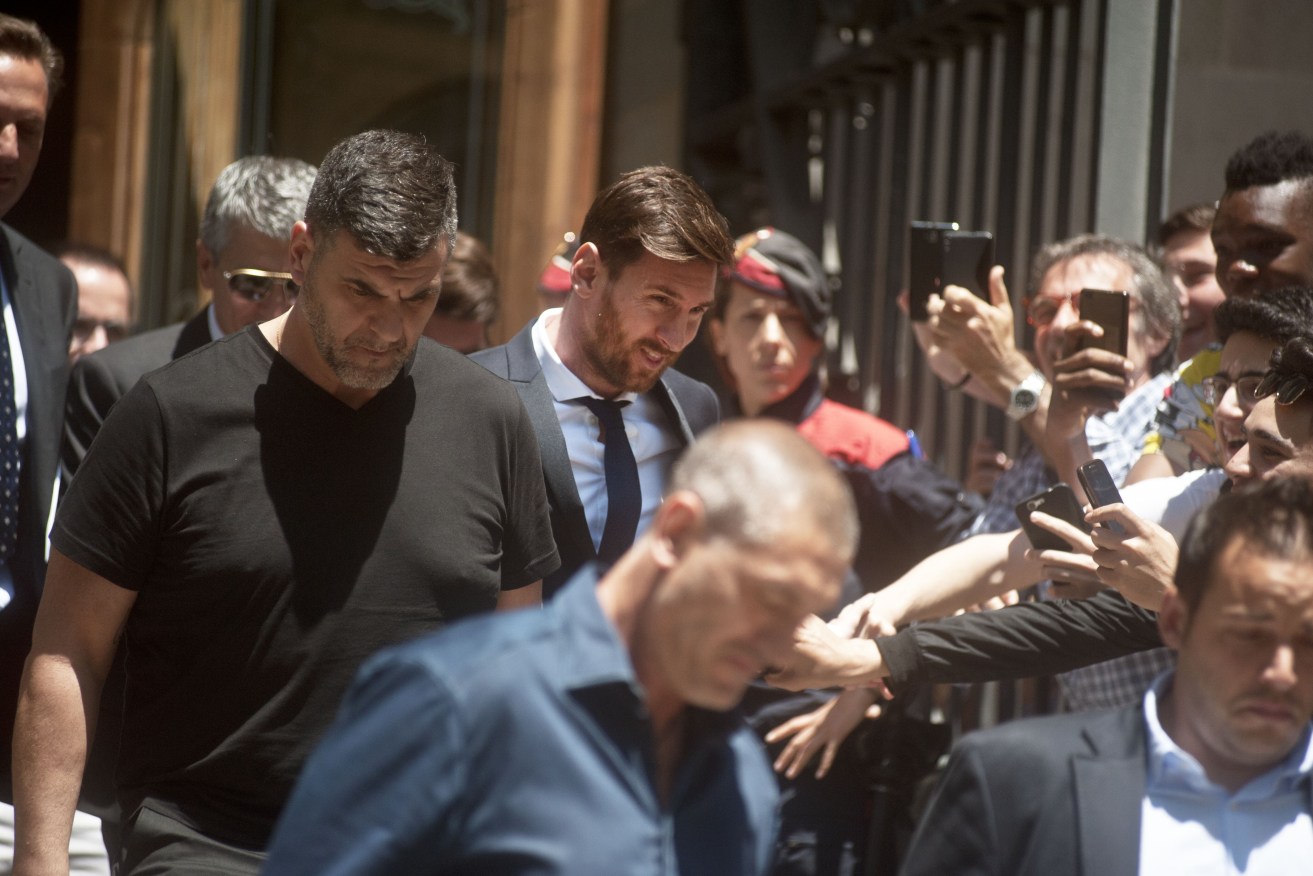 Barcelona's marquee star Lionel Messi was cheered and jeered as he attended court accompanied by his father Jorge Horacio Messi last year. Photo: Claudio Perrone, NewZulu/AAP.