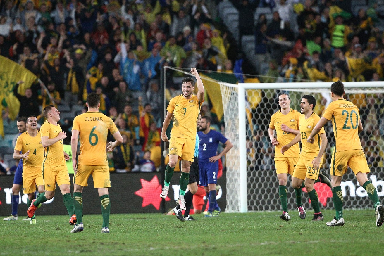 Mathew Leckie pumps his fist after scoring the winning goal during their soccer friendly against Greece in Sydney on Saturday. Photo: Rob Griffith, AP.
