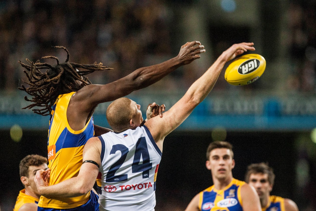 Nic Naitanui and Crows ruckman Sam Jacobs do battle in Saturday night's match. Photo: Tony McDonough, AAP.