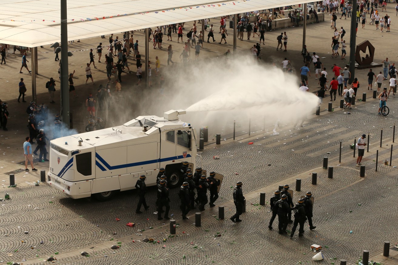 Police firing water cannons to control the fighting after football fans clashed ahead of last month's England vs Russia match.
Photo: Niall Carson, PA Wire.