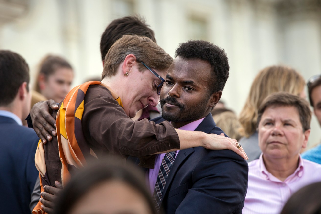 People comfort each other as members of the LGBT Congressional Staff Association and the Congressional Muslim Staff Association gather for a prayer and moment of silence on the steps of the Capitol to stand in solidarity with the Orlando community. Photo: J. Scott Applewhite, AP.