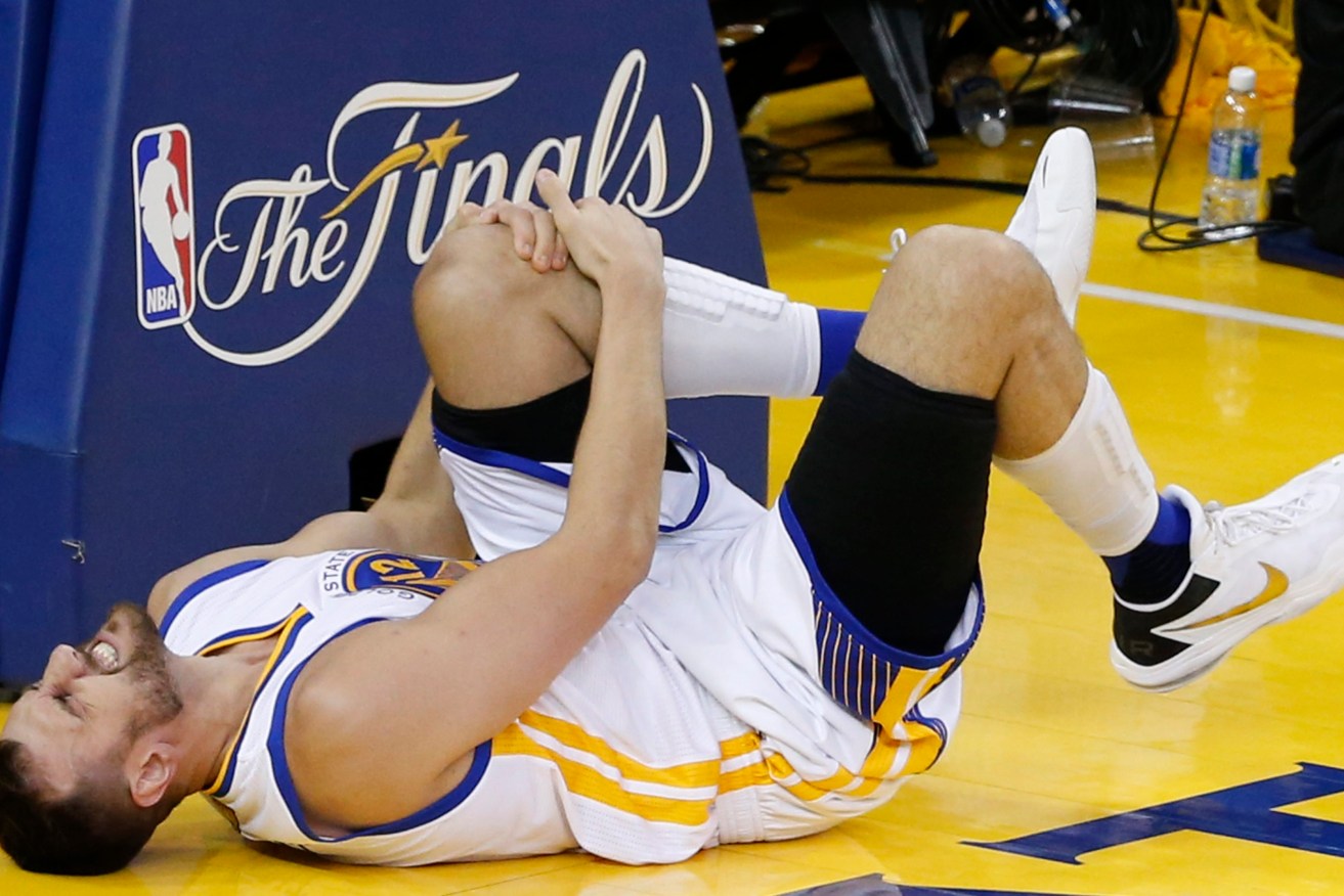 Bogut injures his knee during the second half of game five. Photo: JOHN G. MABANGLO CORBIS OUT, EPA.