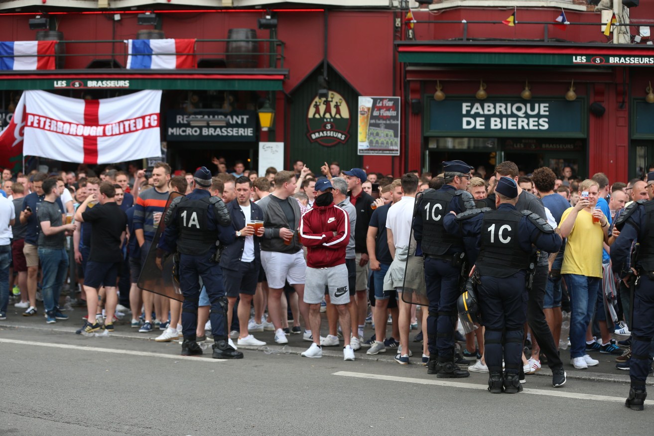 England fans drink outside the train station in Lille city centre, France, as fresh clashes have taken place between England fans and Russian hooligans at Euro 2016. Photo: Niall Carson, PA Wire.