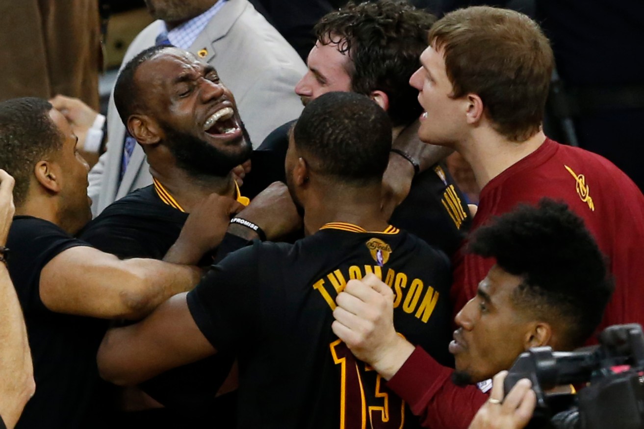 Cleveland Cavaliers players LeBron James, Tristan Thompson and Kevin Love celebrate after beating the Golden State Warriors in the NBA Finals game seven. Photo: JOHN G. MABANGLO CORBIS OUT, EPA.