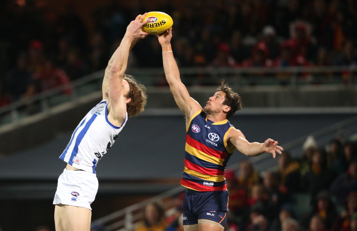 Ben Brown of the Kangaroos contests for a mark in front of Kyle Hartigan of the Crows during the Round fourteen AFL match between the Adelaide Crows and North Melbourne Kangaroos at Adelaide Oval in Adelaide, Thursday, June 23, 2016 (AAP Image/Ben Macmahon) NO ARCHIVING, EDITORIAL USE ONLY