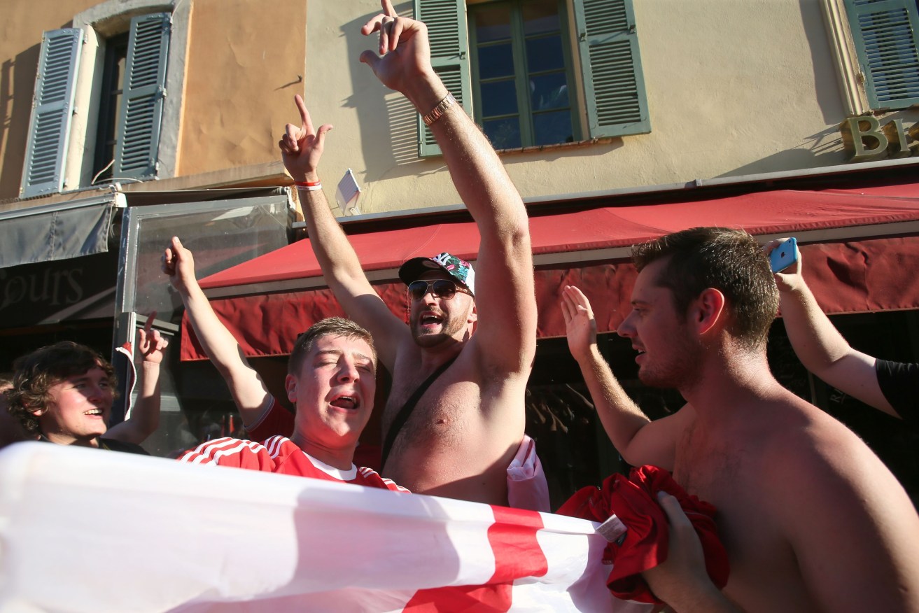 Boxer Tyson Fury poses for pictures with England supporters outside a bar in Nice, France. Photo: Brian Lawless / PA Wire.
