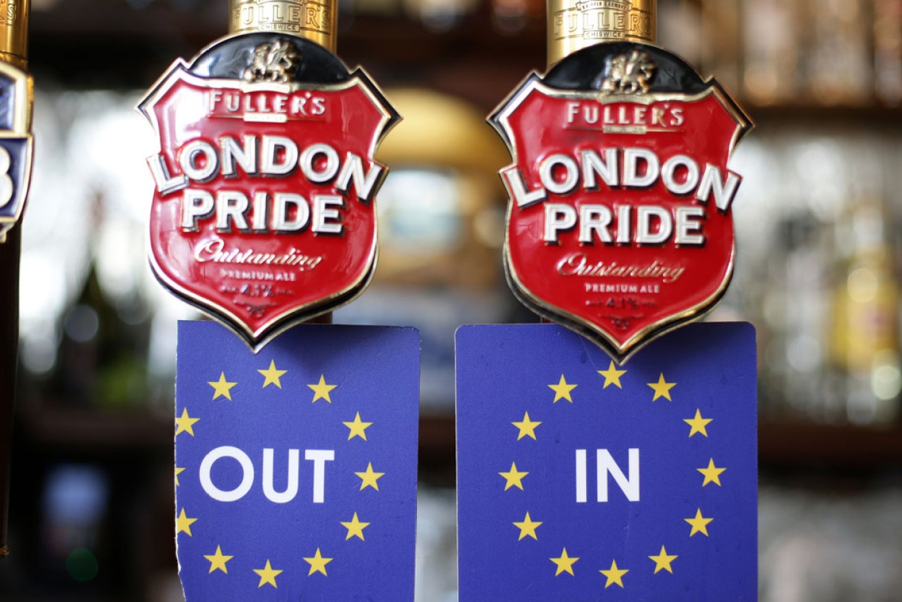 A pair of In and Out beer mats - representing a 'Remain' and 'Leave' stance towards Europe.  Photo: PA