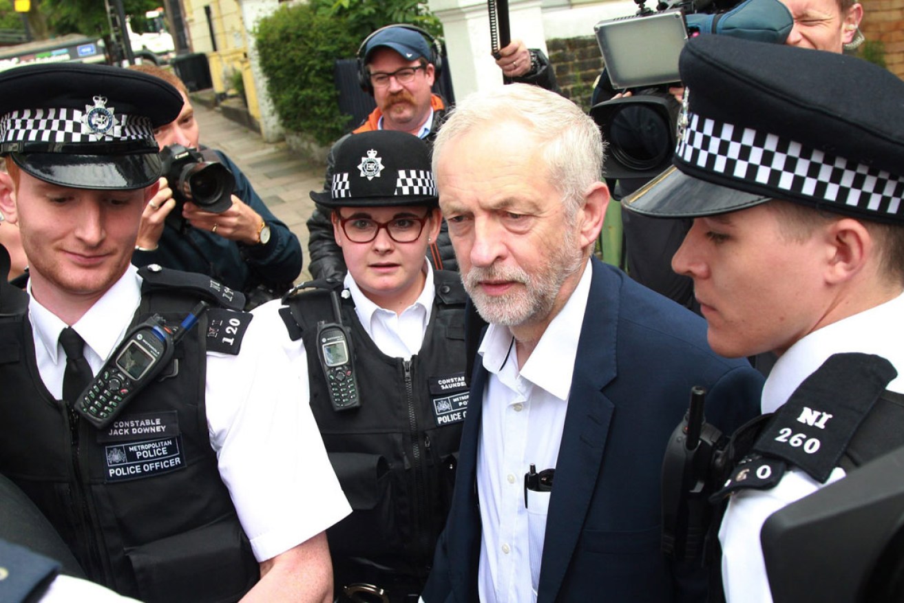 Under pressure: Labour party leader Jeremy Corbyn leaves his home with a police escort. Photo: EPA