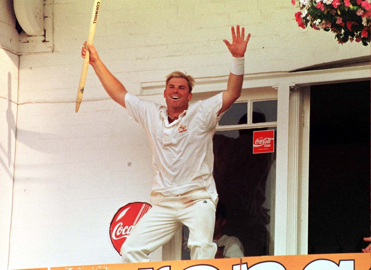 Australian Shane Warne celebrates on the team balcony with his souvenir stump after his side defeated England in the fifth Cornhill Test, and regain the Ashes, at Trent Bridge today (Sunday). Photo by Barry Batchelor/PA. 10/08/1997 (AAP Image/PA) NO ARCHIVING