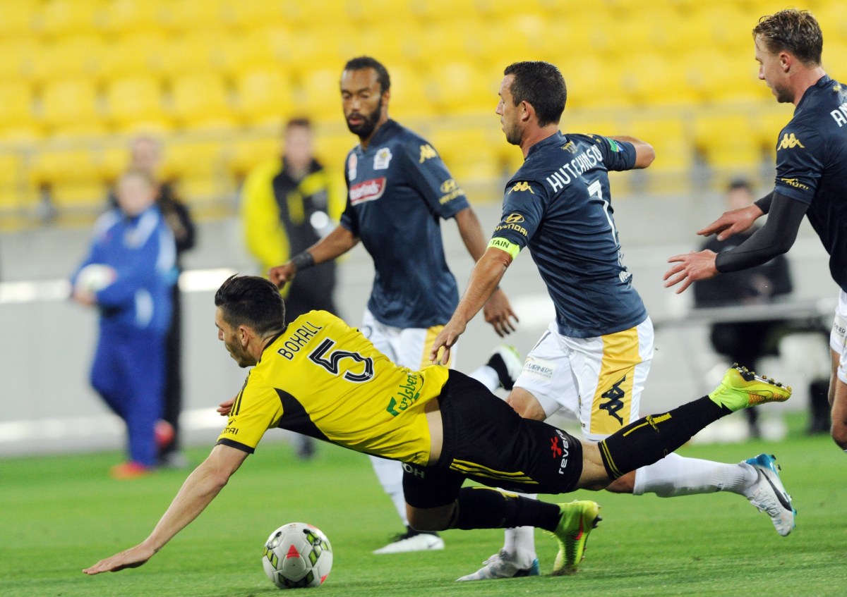 Wellington Phoenix's Michael Bloxall is tackled by Central Coast Mariners' John Hutchinson (right) during their round 26 A-League match at Westpac Stadium, Wellington, New Zealand, Friday, April 17, 2015. (AAP Image/NZN Image/SNPA, Ross Setford) NO ARCHIVING, EDITORIAL USE ONLY, INTL OUT, AUSTRALIA ONLY