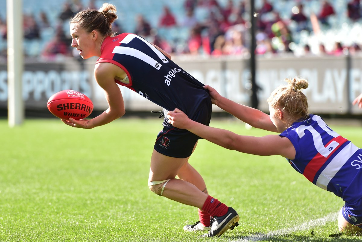 Melbourne Demons player Emma Swanson (left) is tackled by Western Bulldogs player Kellie Gibson during their WAFL game at the MCG in Melbourne, Sunday, May 24, 2015. (AAP Image/Julian Smith) NO ARCHIVING, EDITORIAL USE ONLY