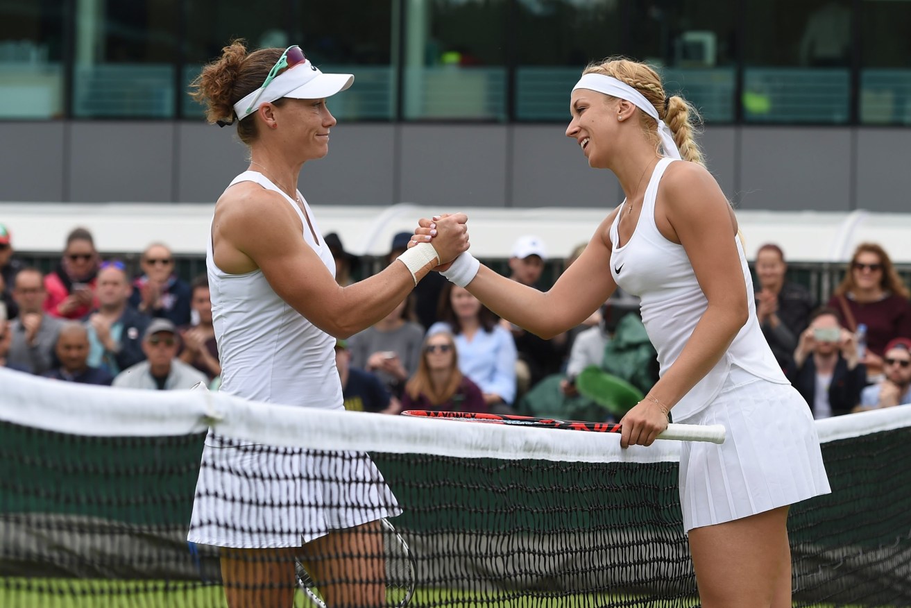 Germany's Sabine Lisicki shakes hands with Samantha Stosur after winning their second round Wimbledon match. Photo: GERRY PENNY, EPA.
