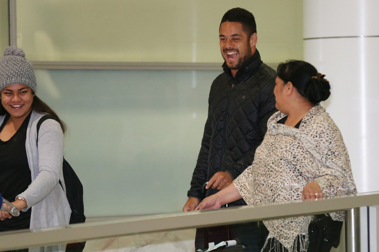 HAYNE'S PLANE: Jarryd Hayne shares a laugh as he walks out into the arrivals hall after arriving from a flight from Fiji. Photo: David Moir, AAP.