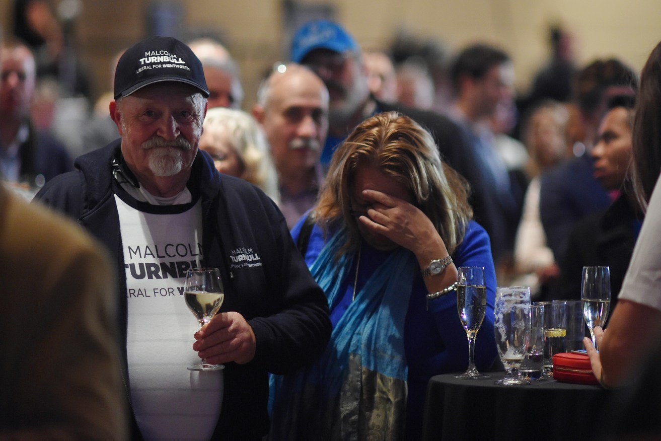 FACEPALM: Liberal party members react as they watch Opposition Leader Bill Shorten on a screen at the Liberal party election night event at the Sofitel Wentworth hotel in Sydney. Photo: Lukas Coch, AAP.