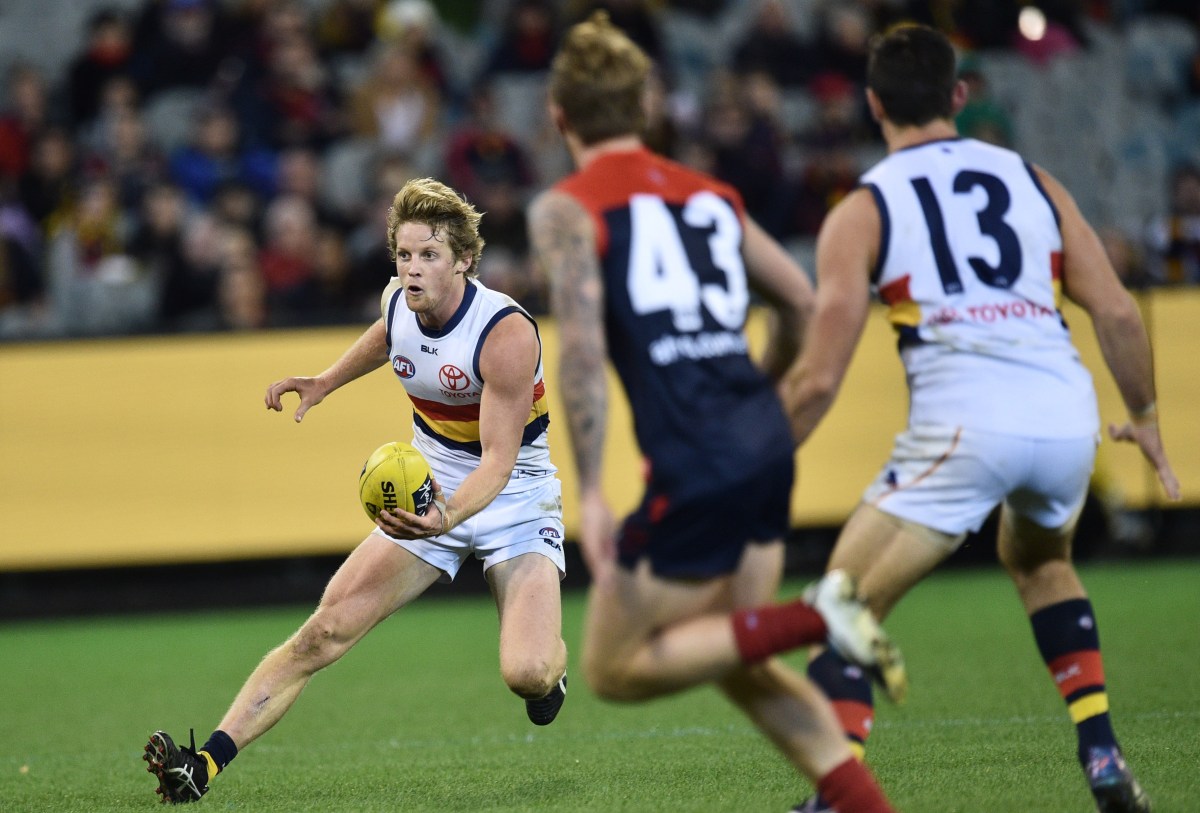 Rory Sloane of the Crows (left) is seen in action during the Round 15 AFL match between the Melbourne Demons and the Adelaide Crows at the MCG in Melbourne, Sunday, July 3, 2016. (AAP Image/Julian Smith) NO ARCHIVING, EDITORIAL USE ONLY